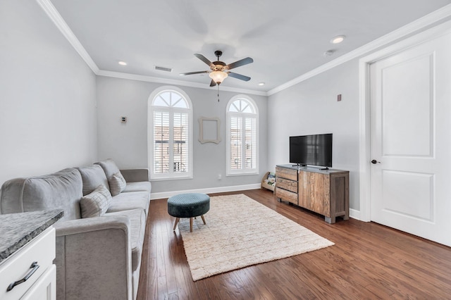 living room with ornamental molding, dark wood-type flooring, and ceiling fan