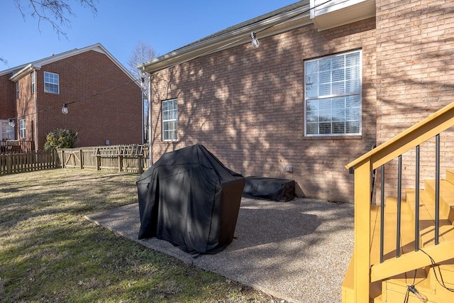 view of home's exterior featuring a patio and a lawn