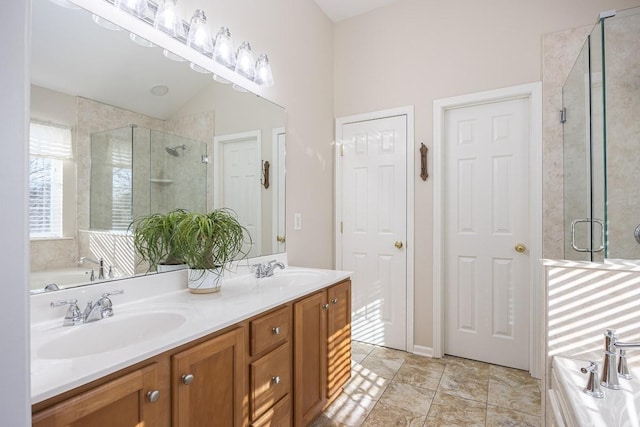 bathroom with independent shower and bath, vanity, and vaulted ceiling