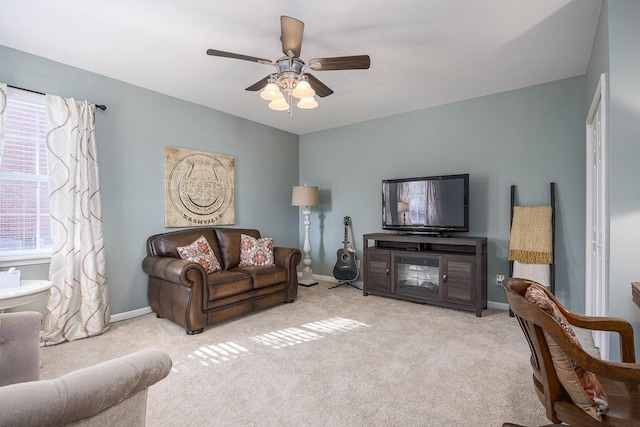 carpeted living room featuring ceiling fan