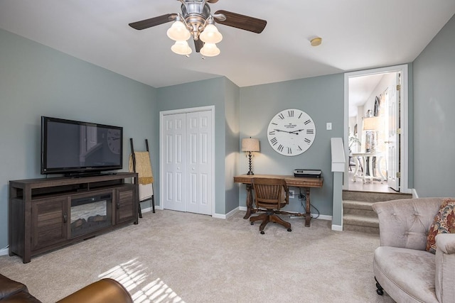 office area featuring light carpet and ceiling fan