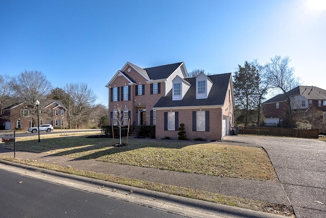 view of front of property featuring a garage and a front yard