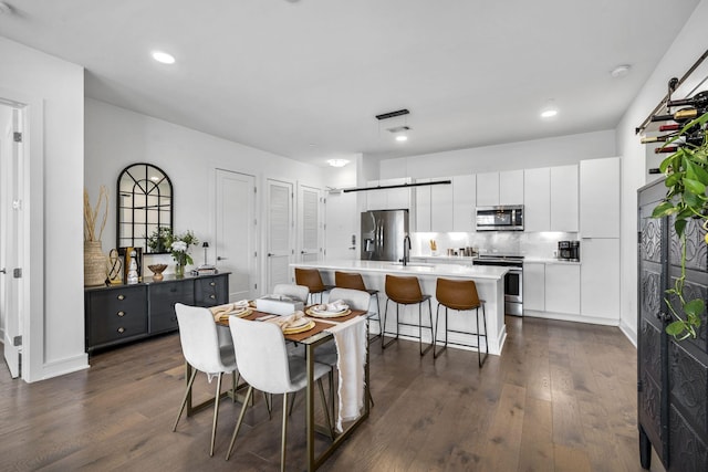 dining space featuring dark wood-type flooring