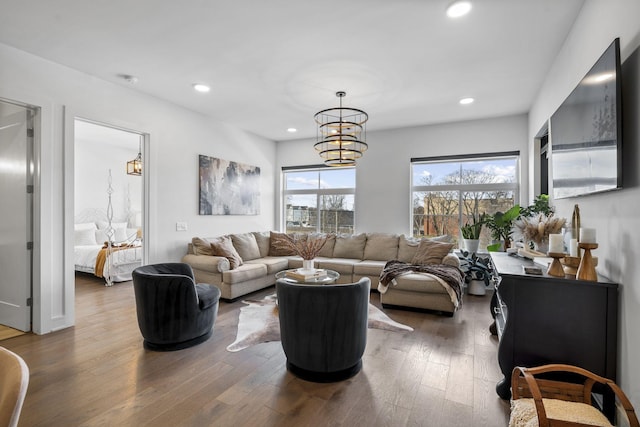 living room featuring a notable chandelier, wood-type flooring, and plenty of natural light