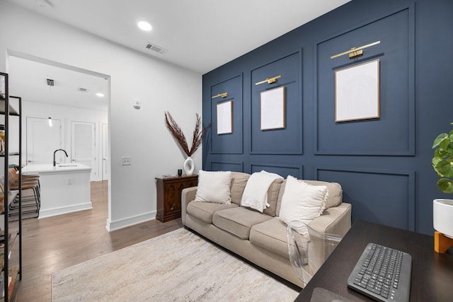 living room featuring dark hardwood / wood-style floors and sink