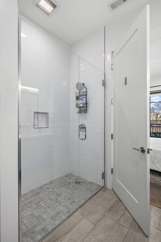 bathroom with a shower with door