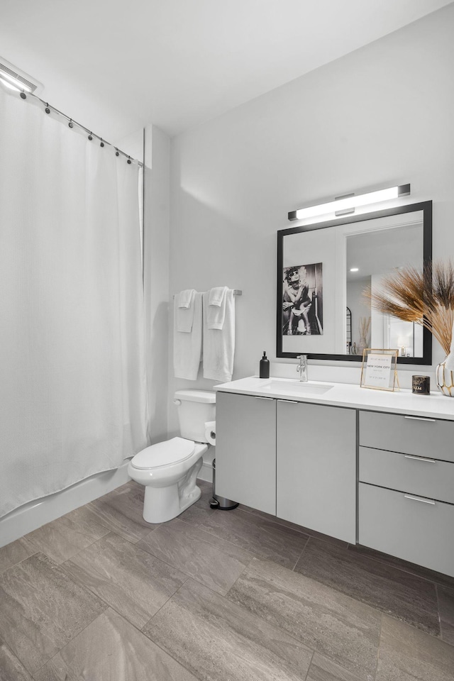 bathroom featuring vanity and toilet