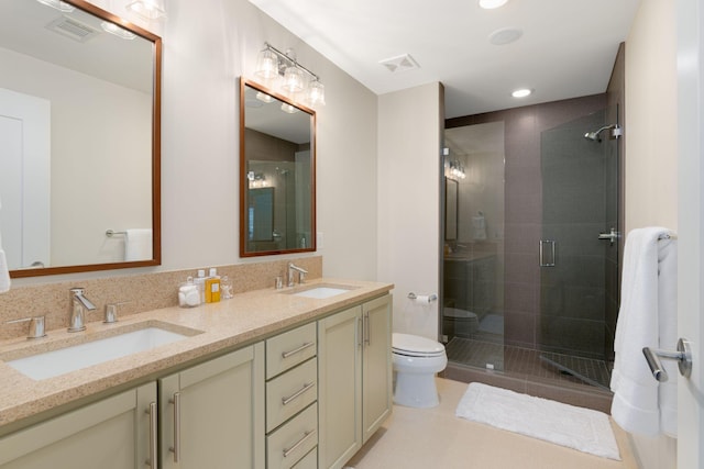 bathroom with vanity, toilet, tile patterned flooring, and a shower with door