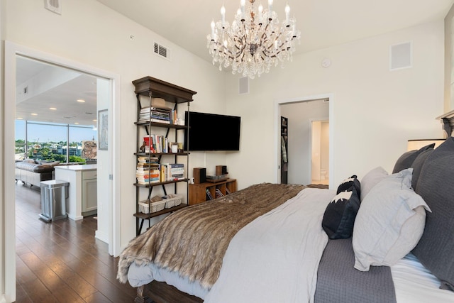 bedroom featuring dark wood-type flooring and a notable chandelier