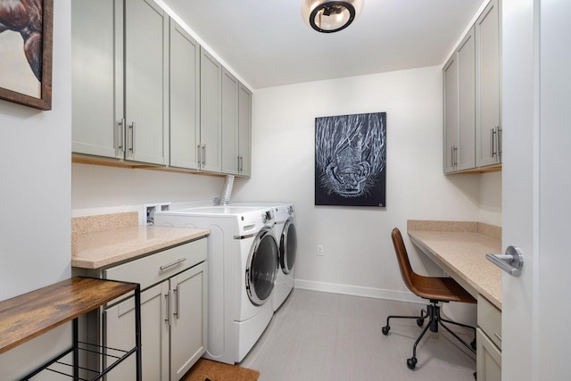 laundry room featuring cabinets and washer and dryer