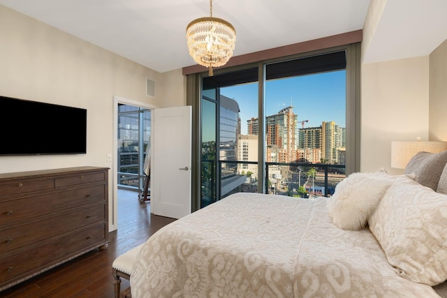 bedroom featuring dark wood-type flooring, access to outside, and a chandelier