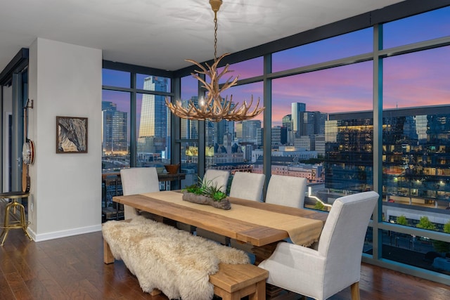 dining room with expansive windows, dark hardwood / wood-style flooring, and a notable chandelier