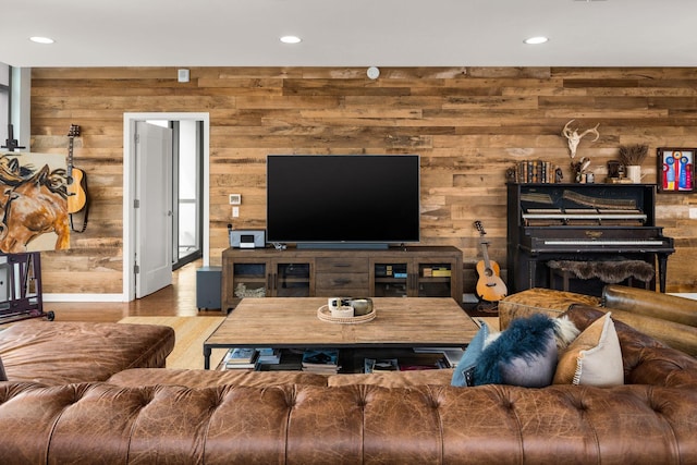 living room featuring hardwood / wood-style flooring and wooden walls