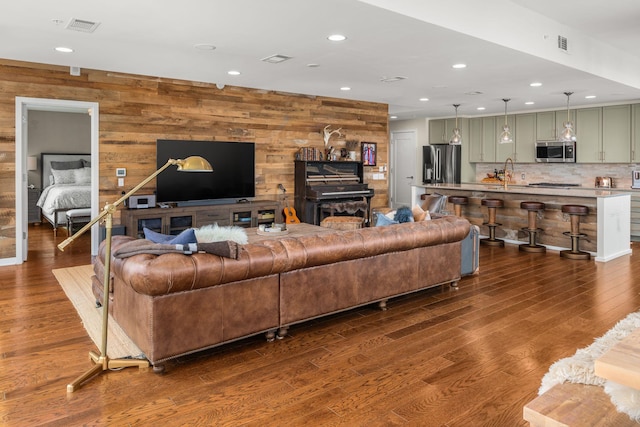 living room with sink and dark hardwood / wood-style flooring