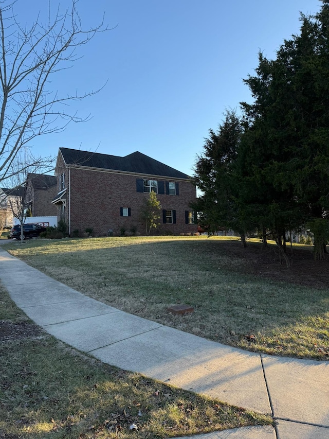 view of home's exterior with a yard