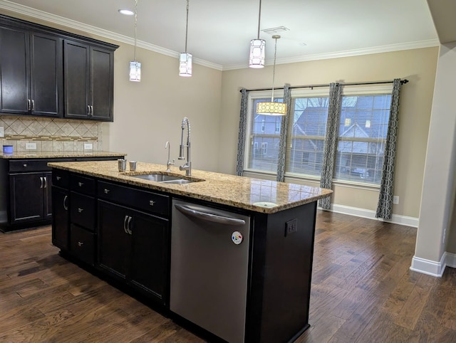 kitchen with pendant lighting, sink, dishwasher, a kitchen island with sink, and light stone countertops