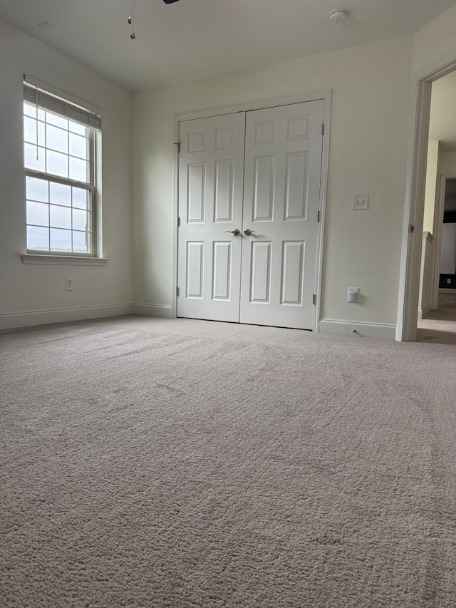 unfurnished bedroom with a closet and carpet flooring