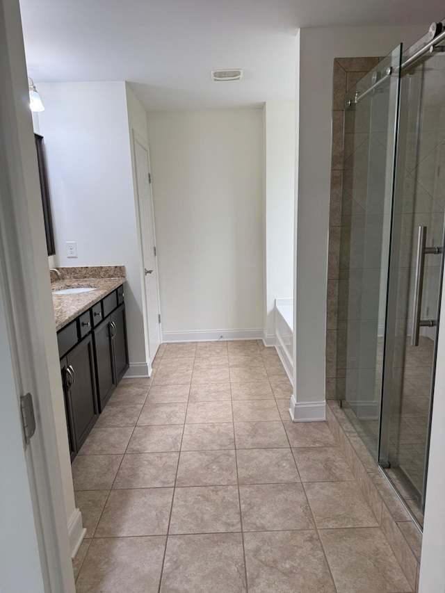 bathroom featuring tile patterned floors, vanity, and plus walk in shower