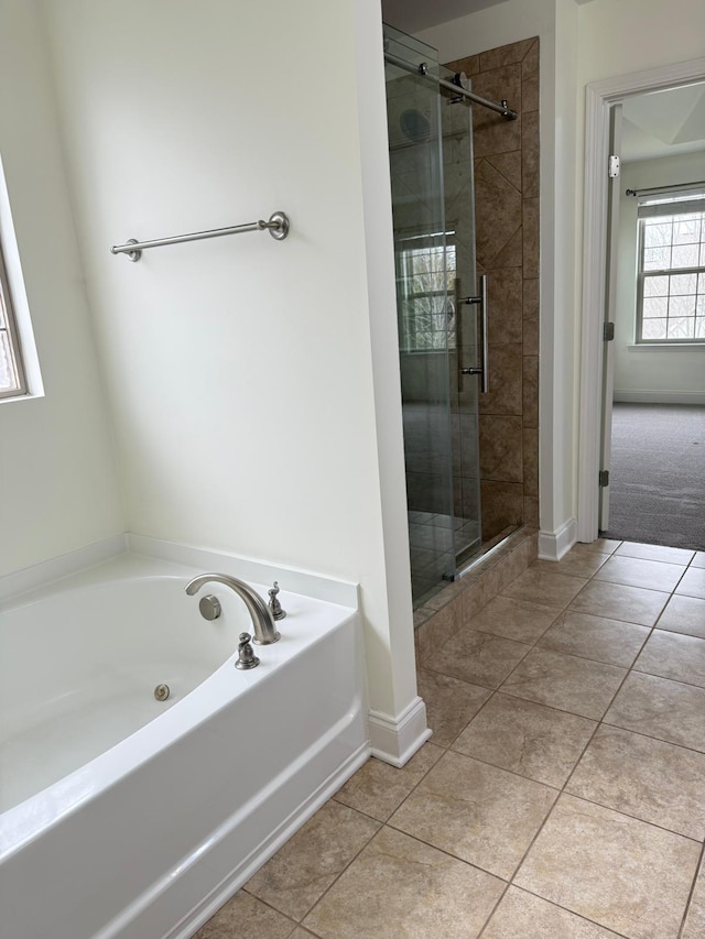 bathroom featuring tile patterned floors and separate shower and tub