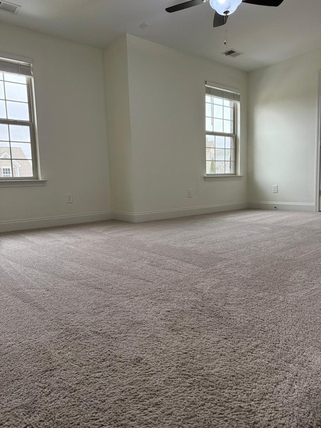 unfurnished room with ceiling fan and carpet floors