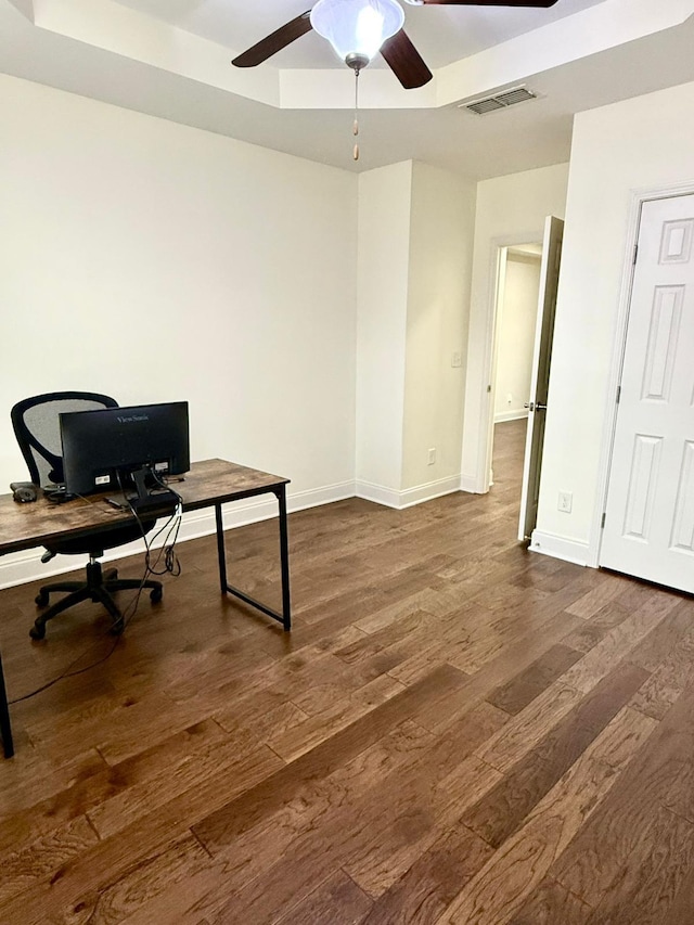 office space with dark wood-type flooring and ceiling fan