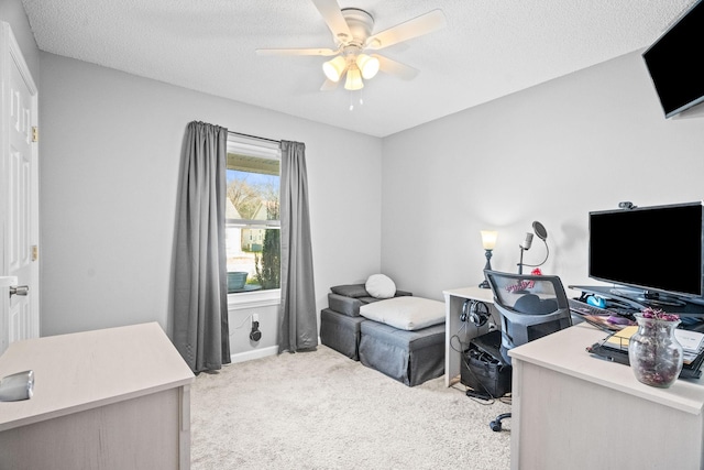 office with ceiling fan, light carpet, and a textured ceiling