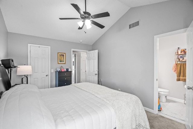 bedroom featuring lofted ceiling, connected bathroom, carpet floors, and ceiling fan