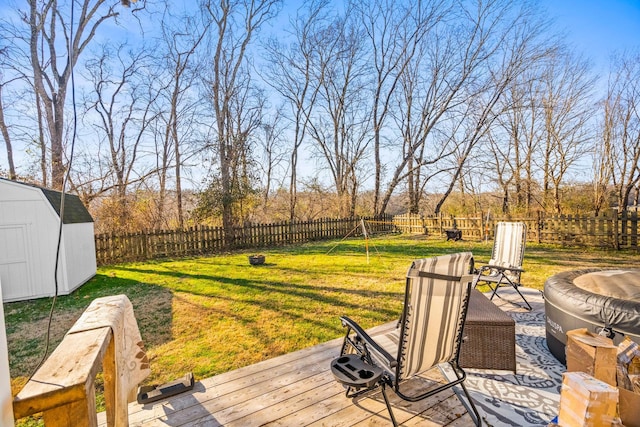 deck with a storage shed and a lawn