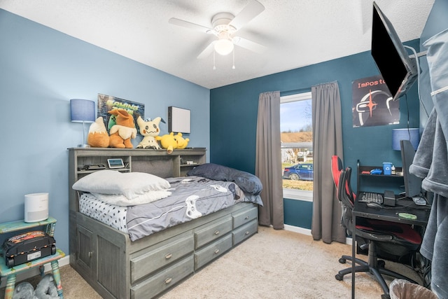 bedroom with a textured ceiling, light colored carpet, and ceiling fan