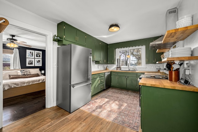 kitchen with stainless steel appliances, a healthy amount of sunlight, and green cabinets