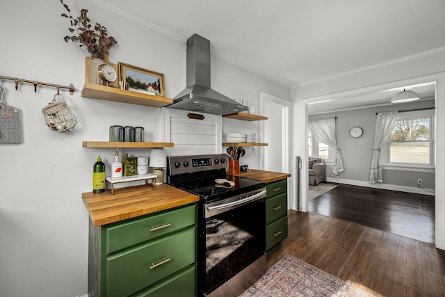 kitchen with butcher block counters, extractor fan, stainless steel range with electric cooktop, and green cabinets