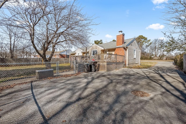 view of property exterior with a wooden deck