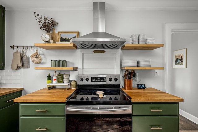 kitchen featuring stainless steel electric stove, butcher block counters, island range hood, and green cabinetry