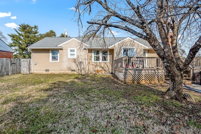 rear view of house with a lawn and a deck