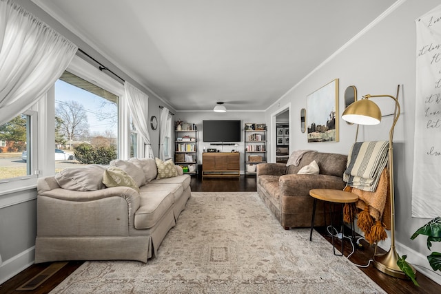 living room with hardwood / wood-style flooring and ornamental molding