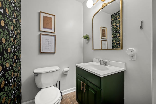 bathroom with tile patterned floors, vanity, and toilet