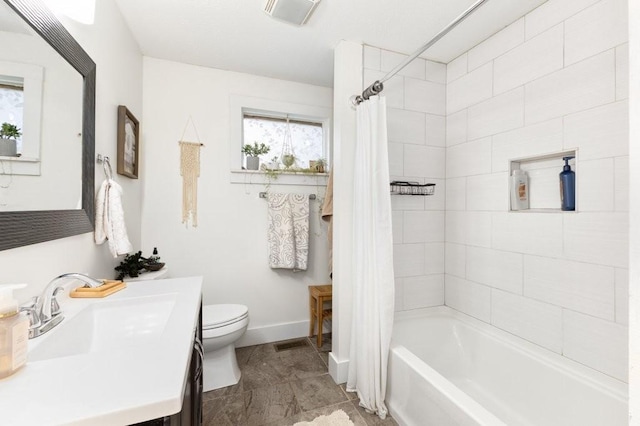 full bathroom with vanity, shower / bath combo with shower curtain, and toilet