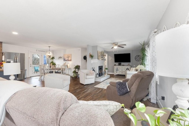 living room featuring dark wood-type flooring and ceiling fan