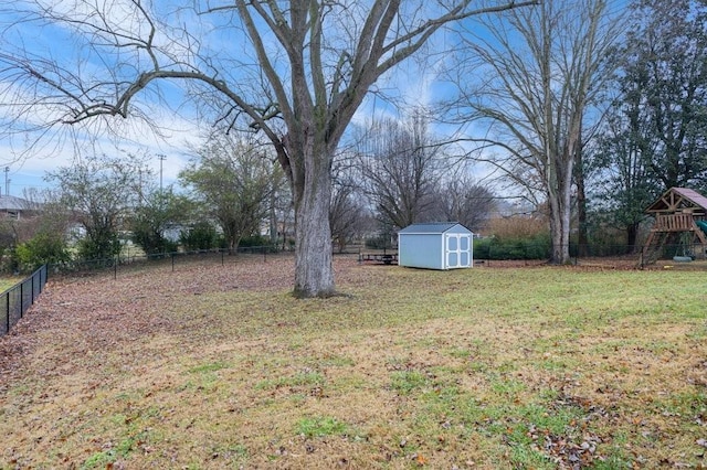 view of yard featuring a storage shed and a playground