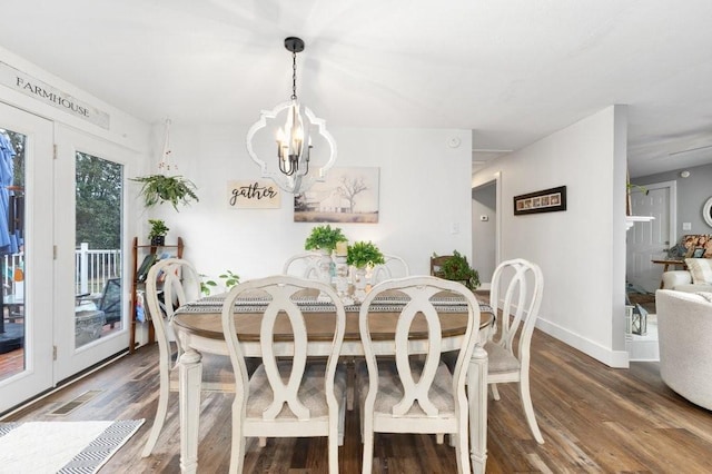 dining area featuring an inviting chandelier and dark hardwood / wood-style flooring