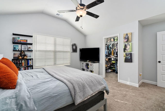 bedroom featuring lofted ceiling, a spacious closet, light colored carpet, a closet, and ceiling fan