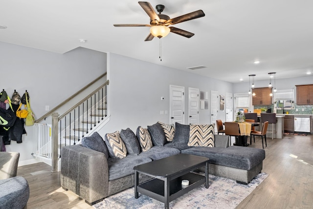 living room featuring hardwood / wood-style flooring and ceiling fan