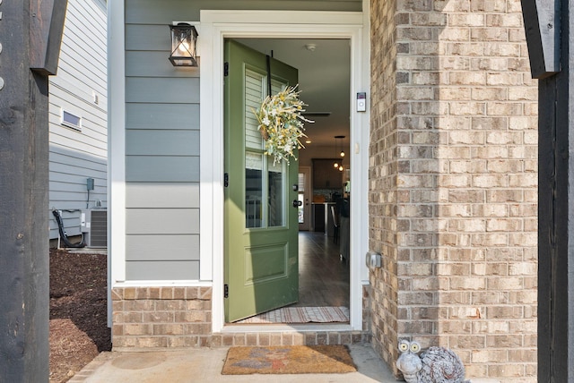 doorway to property featuring central air condition unit