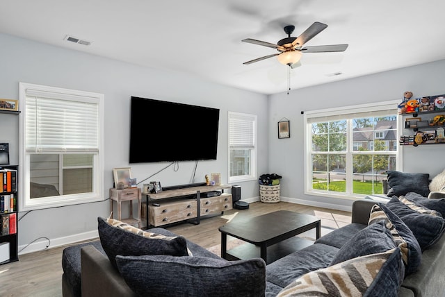 living room with ceiling fan and light hardwood / wood-style flooring