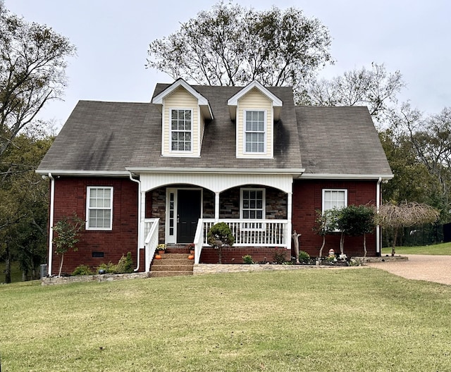 cape cod house with covered porch and a front lawn