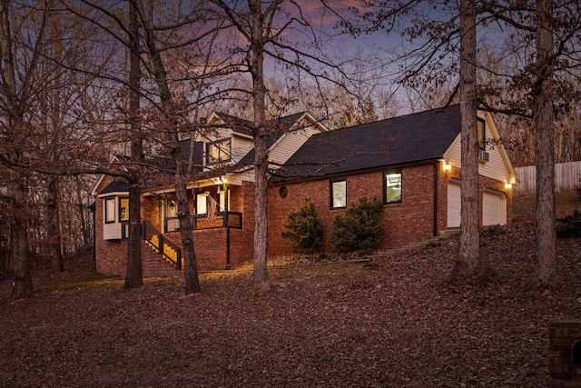 property exterior at dusk featuring a garage