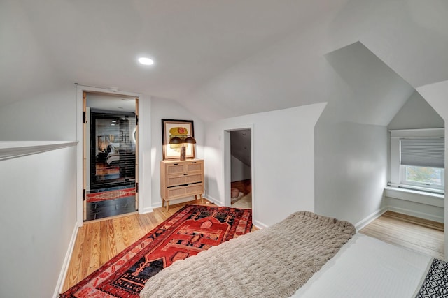 bedroom featuring hardwood / wood-style flooring and vaulted ceiling