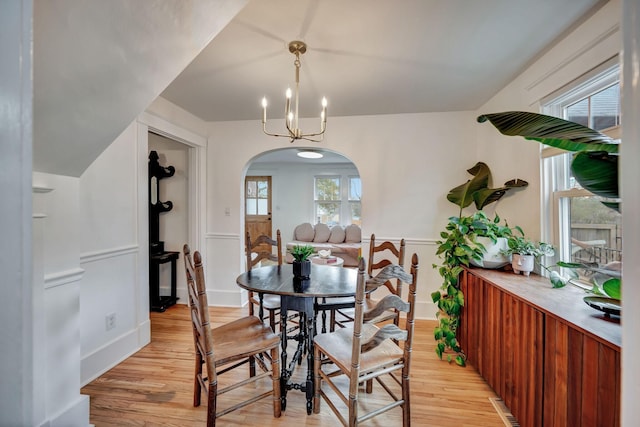 dining space with an inviting chandelier and light hardwood / wood-style floors