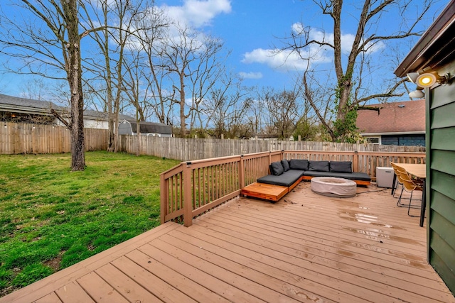 wooden terrace featuring a yard and an outdoor living space with a fire pit