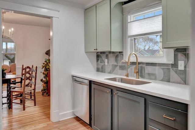 kitchen with dishwasher, sink, a healthy amount of sunlight, and light hardwood / wood-style floors